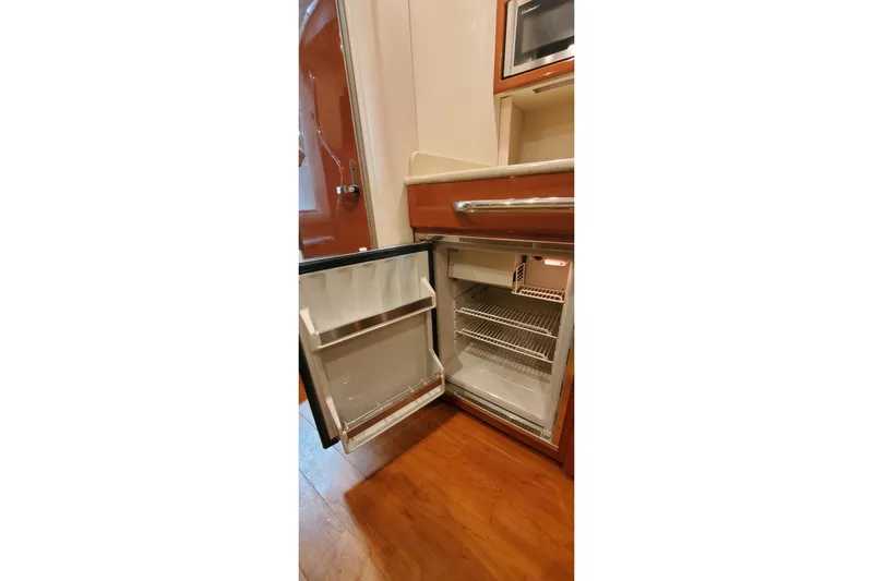  Yacht Photos Pics Open refrigerator inside 2010 Formula 31 Performance Cruiser, showcasing interior shelves and door storage.