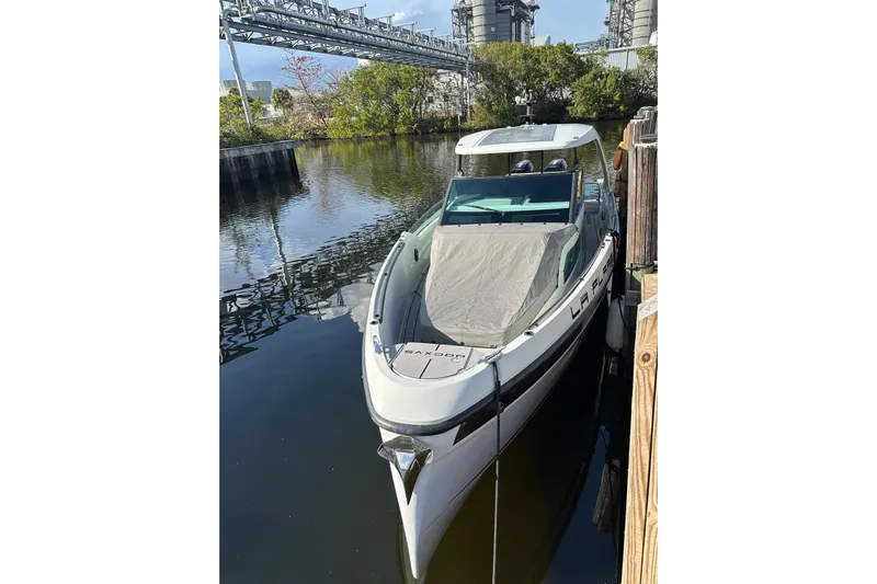 La Flare Yacht Photos Pics 2023 Saxdor 320 GTO boat docked in a serene waterway setting.