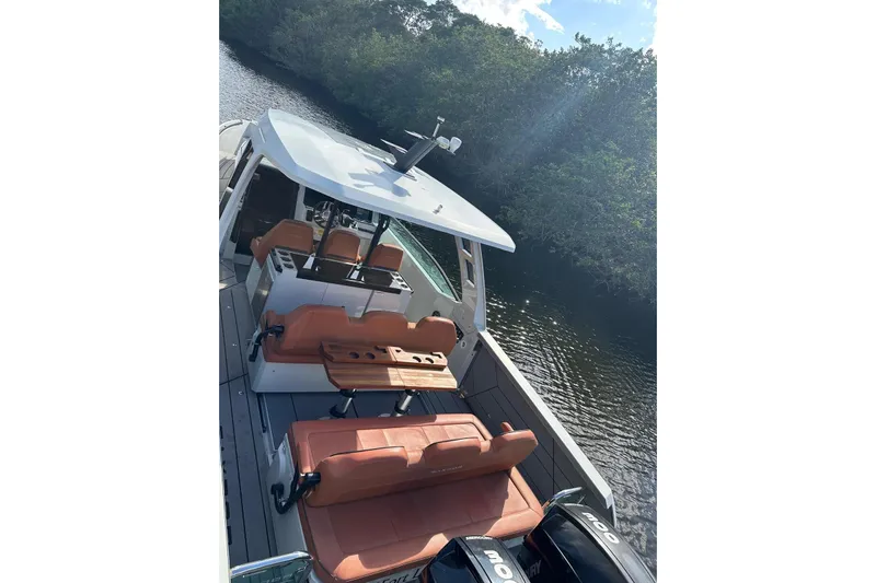 La Flare Yacht Photos Pics 2023 Saxdor 320 GTO boat with sleek design and luxurious seating on a serene waterway.
