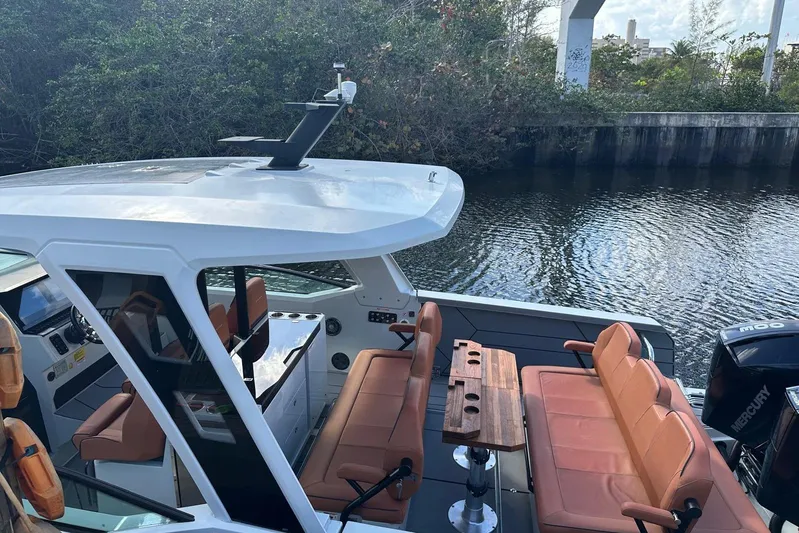 La Flare Yacht Photos Pics 2023 Saxdor 320 GTO boat with sleek design and comfortable seating on a calm waterway.