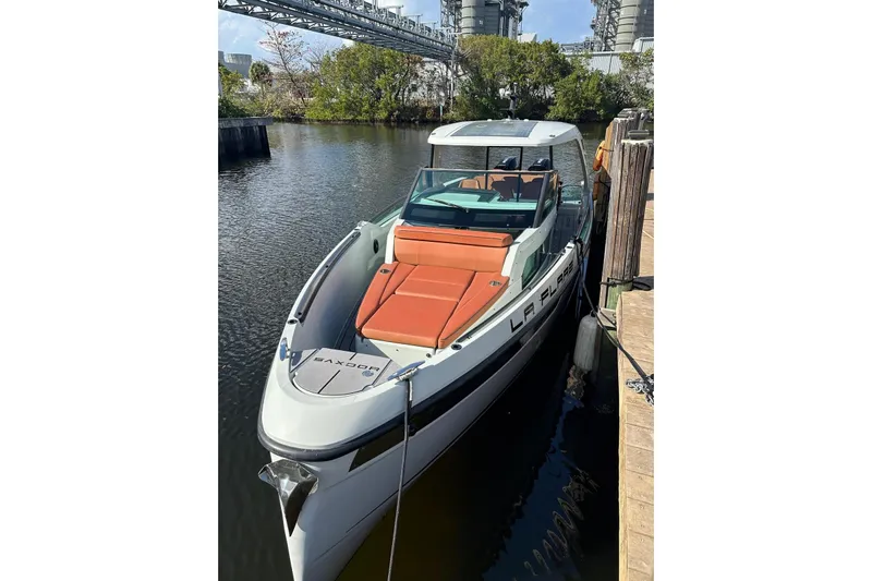 La Flare Yacht Photos Pics 2023 Saxdor 320 GTO boat docked, featuring sleek design and orange seating.