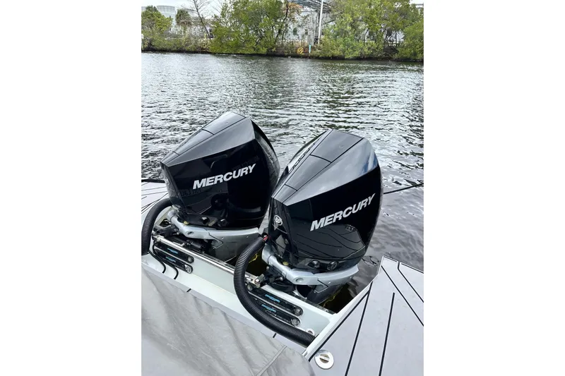 La Flare Yacht Photos Pics Twin Mercury outboard engines on a 2023 Saxdor 320 GTO boat by the water.