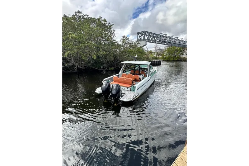 La Flare Yacht Photos Pics 2023 Saxdor 320 GTO boat on water near trees and bridge, featuring dual engines.