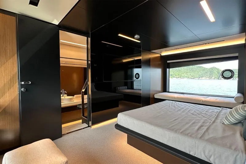  Yacht Photos Pics Luxurious bedroom interior of 2024 Riva 102' Corsaro Super yacht with ocean view.