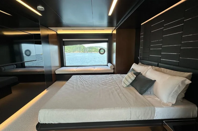  Yacht Photos Pics Luxurious bedroom interior of 2024 Riva 102' Corsaro Super yacht with ocean view.