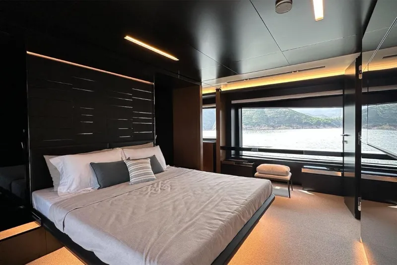  Yacht Photos Pics Luxurious bedroom interior of 2024 Riva 102' Corsaro Super yacht with scenic ocean view.