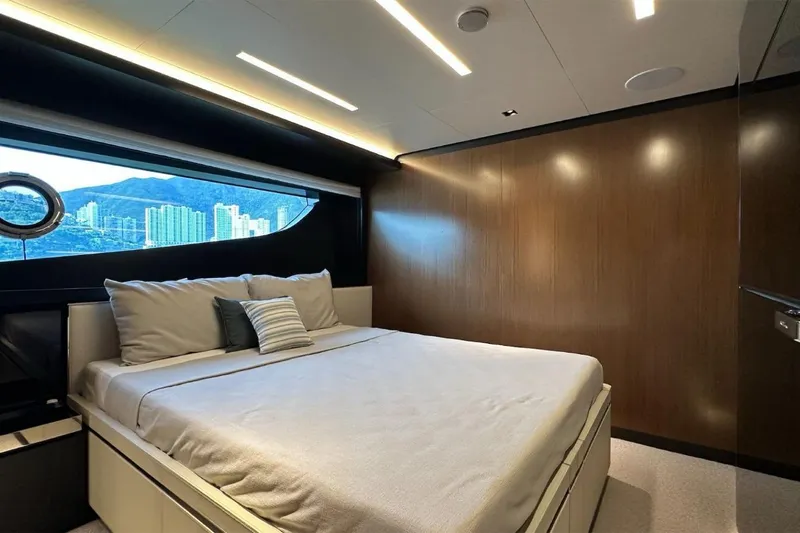  Yacht Photos Pics Luxurious bedroom interior of 2024 Riva 102' Corsaro Super yacht with scenic window view.