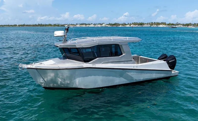  Yacht Photos Pics Novielli Alaskan 296 boat, 2026 model, cruising on clear blue water.