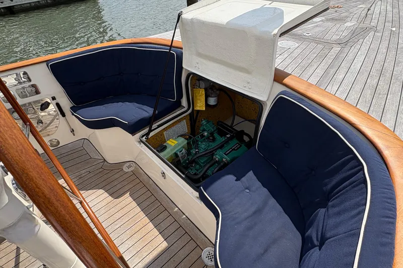 Arethusa Yacht Photos Pics Interior of 2017 Leonardo Eagle 44 yacht with open engine compartment and blue cushioned seating.