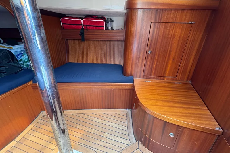 Arethusa Yacht Photos Pics Interior of 2017 Leonardo Eagle 44 yacht with wooden finish and blue cushions.
