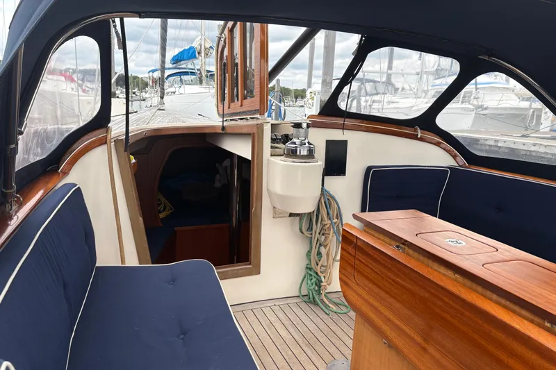 Arethusa Yacht Photos Pics Interior view of 2017 Leonardo Eagle 44 sailboat with wooden and navy blue seating.