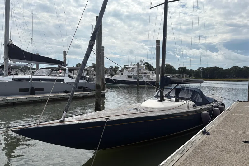 Arethusa Yacht Photos Pics Sleek 2017 Leonardo Eagle 44 sailboat docked at a marina under a cloudy sky.
