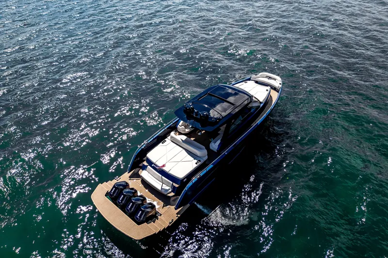  Yacht Photos Pics Aerial view of 2025 Dutch American DA 53 boat cruising on clear blue water.