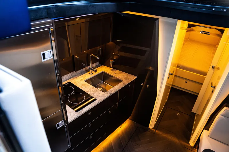  Yacht Photos Pics Modern kitchen interior in 2025 Dutch American DA 53 yacht, featuring sleek design and ambient lighting.