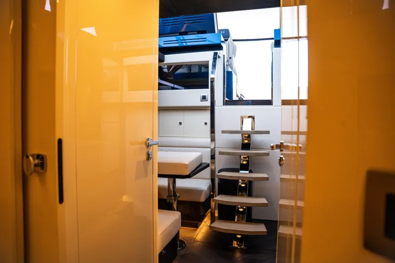  Yacht Photos Pics Interior view of 2025 Dutch American DA 53 yacht, featuring modern stairs and seating.