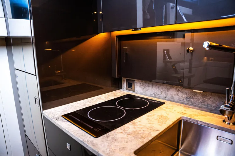  Yacht Photos Pics Modern kitchen with sleek design, featuring a Dutch American DA 53 cooktop, 2025 model.