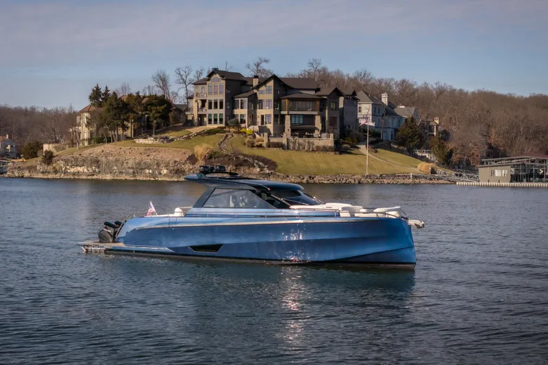  Yacht Photos Pics Luxurious 2025 Dutch American DA 53 yacht on serene lake with elegant waterfront homes.