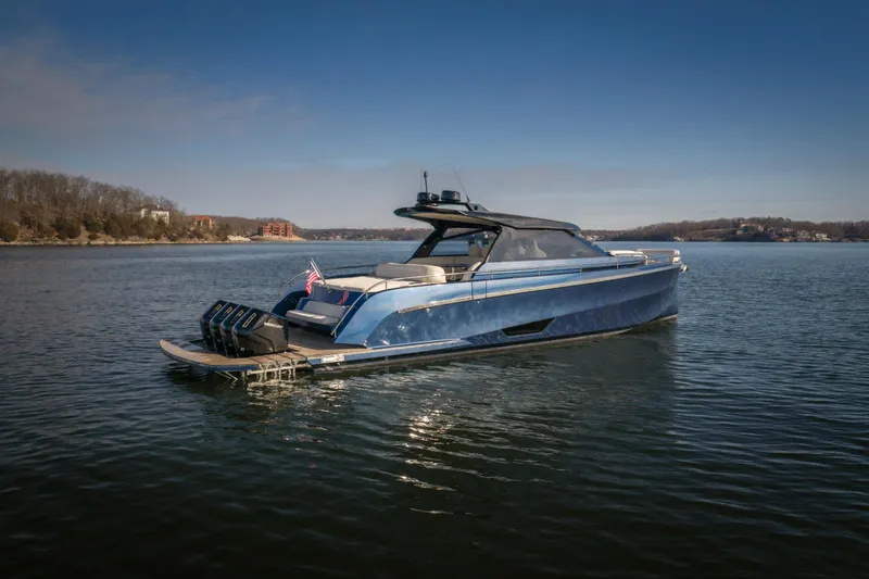  Yacht Photos Pics Luxury 2025 Dutch American DA 53 yacht on serene lake with clear blue sky.