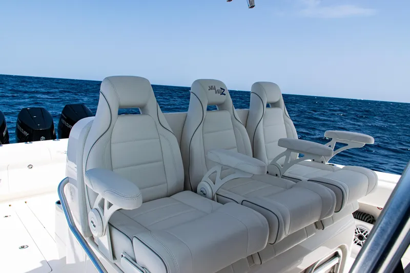  Yacht Photos Pics 2025 SeaVee 400Z boat with luxurious white seating, ocean backdrop.