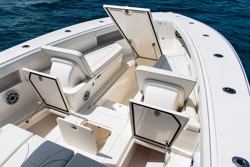  Yacht Photos Pics 2025 SeaVee 400Z boat interior with open storage compartments, white seating, and ocean backdrop.