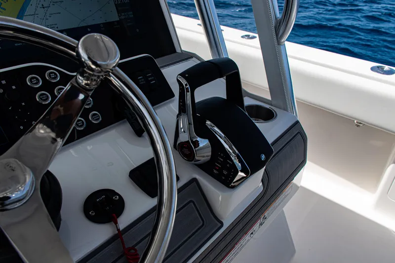  Yacht Photos Pics 2025 SeaVee 400Z boat helm with steering wheel and throttle controls.