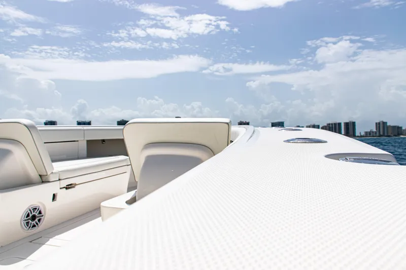  Yacht Photos Pics 2025 SeaVee 400Z boat deck with seating, under a clear blue sky.