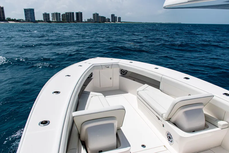  Yacht Photos Pics 2025 SeaVee 400Z boat on ocean, city skyline in background.