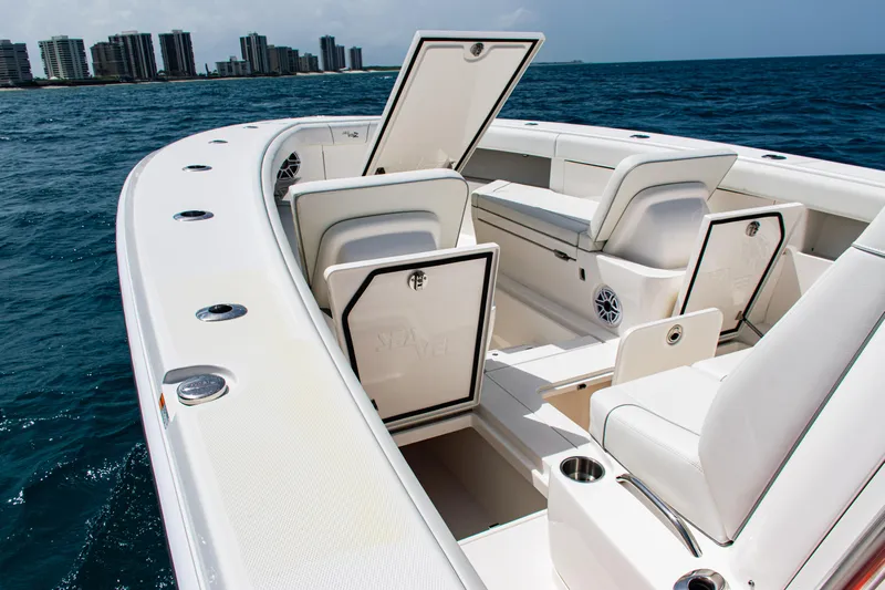  Yacht Photos Pics 2025 SeaVee 400Z boat interior with open storage compartments, on the ocean near city skyline.