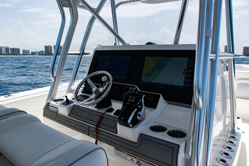  Yacht Photos Pics 2025 SeaVee 400Z boat helm with modern navigation system on open water.