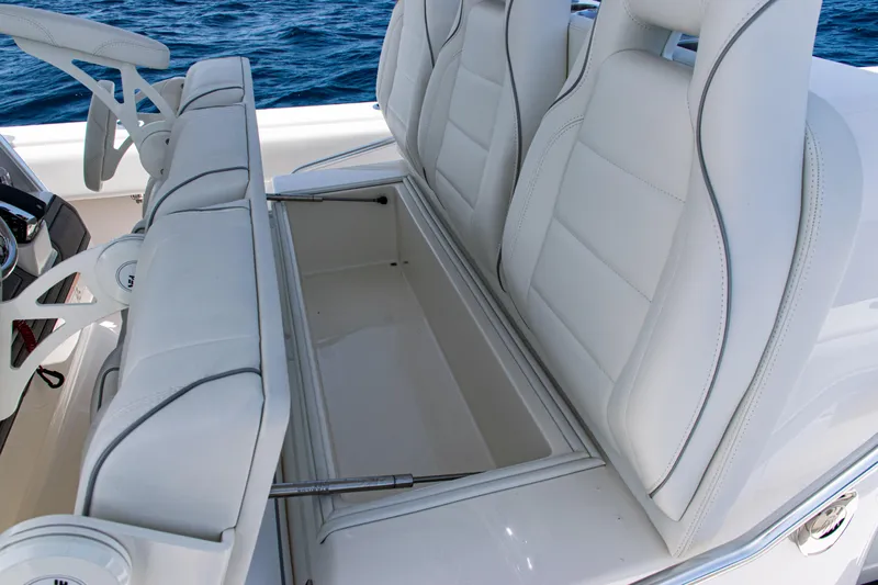  Yacht Photos Pics 2025 SeaVee 400Z boat with open storage compartment and white cushioned seats.