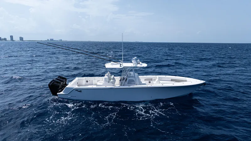  Yacht Photos Pics 2025 SeaVee 400Z boat on open ocean, clear sky, fishing rods visible.