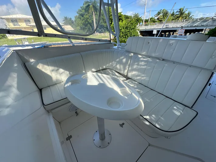  Yacht Photos Pics 2005 Intrepid 348 WA boat interior with white seating and round table.