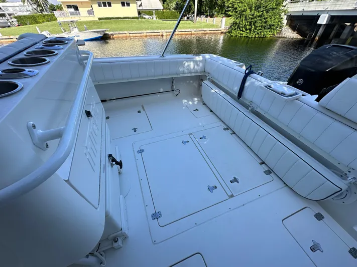  Yacht Photos Pics 2005 Intrepid 348 WA boat deck with seating and storage, docked by a canal.