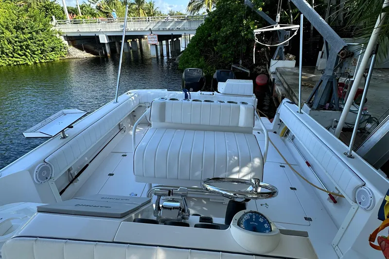  Yacht Photos Pics 2005 Intrepid 348 WA boat interior with white seating and steering wheel.