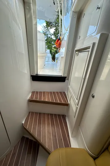  Yacht Photos Pics Interior view of 2005 Intrepid 348 WA boat with wooden steps and sleek design.