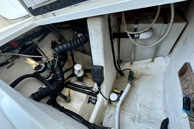  Yacht Photos Pics Engine compartment of a 2005 Intrepid 348 WA boat, showing hoses and mechanical components.