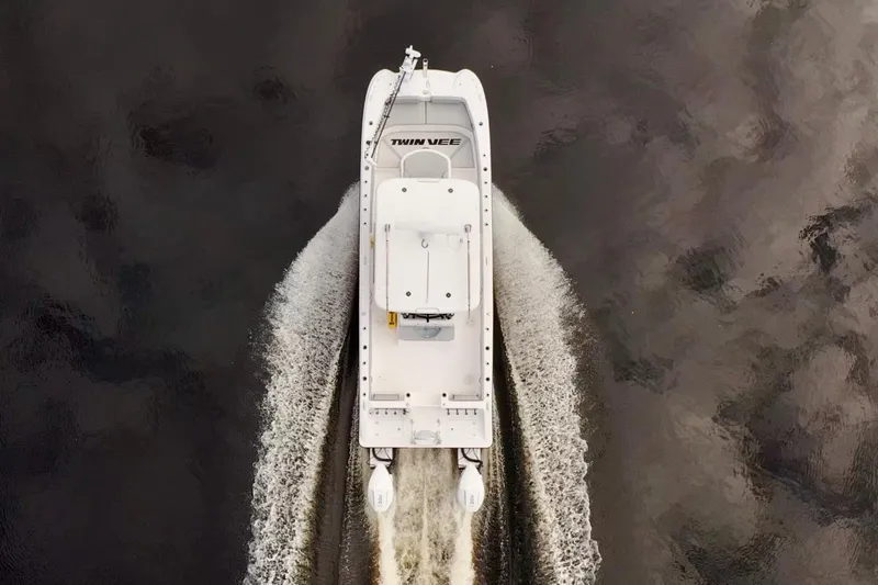  Yacht Photos Pics Aerial view of 2024 Twin Vee 280 GFX CC boat cruising on water.