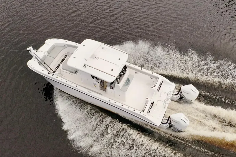  Yacht Photos Pics 2024 Twin Vee 280 GFX CC boat cruising on water, aerial view.