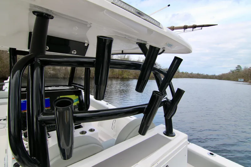  Yacht Photos Pics 2024 Twin Vee 280 GFX CC boat with rod holders on a serene river.