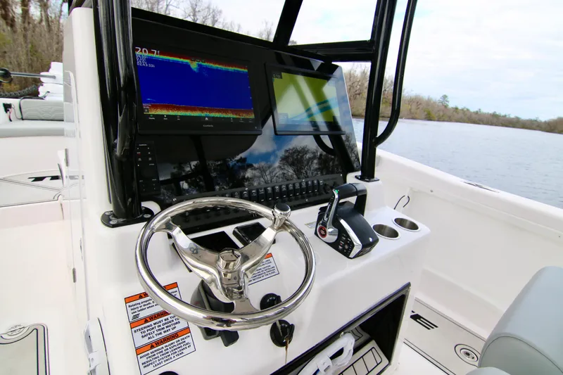  Yacht Photos Pics 2024 Twin Vee 280 GFX CC boat console with steering wheel and navigation display.