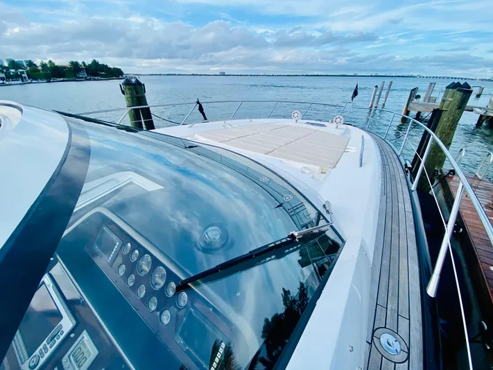 Essence Yacht Photos Pics 2010 Sunseeker Predator 60 yacht docked with scenic water view.