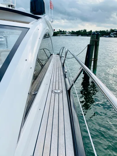 Essence Yacht Photos Pics 2010 Sunseeker Predator 60 yacht docked by the water.