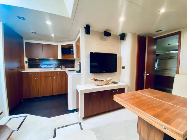 Essence Yacht Photos Pics Luxurious interior of 2010 Sunseeker Predator 60 yacht with modern kitchen and entertainment area.