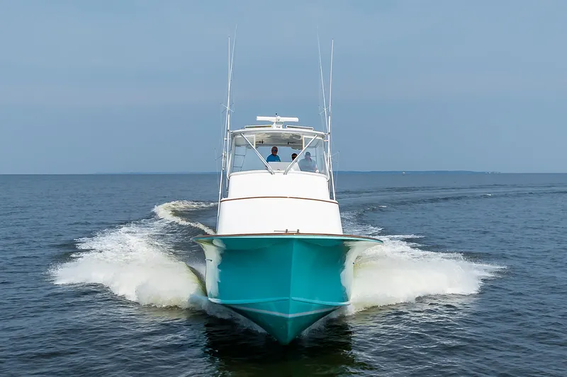 Sea Horse Yacht Photos Pics Custom Carolina 43 Blackwell Convertible 1994 cruising on open water, front view.