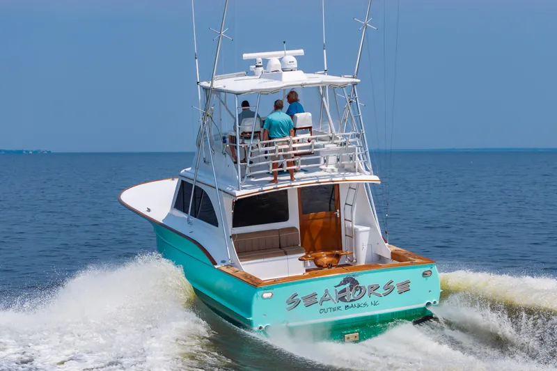 Sea Horse Yacht Photos Pics Custom Carolina 43 Blackwell Convertible boat cruising on open water, 1994 model.