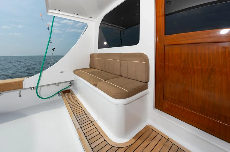 Sea Horse Yacht Photos Pics 1994 Custom Carolina 43 Blackwell Convertible boat interior with cushioned seating and wooden accents.