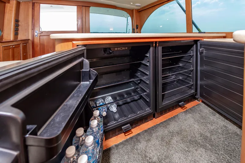 Sea Horse Yacht Photos Pics Interior of 1994 Custom Carolina 43 Blackwell Convertible with open fridge and water bottles.