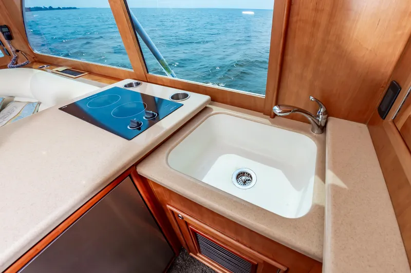 Sea Horse Yacht Photos Pics Interior of 1994 Custom Carolina 43 Blackwell Convertible with kitchen sink and stovetop.
