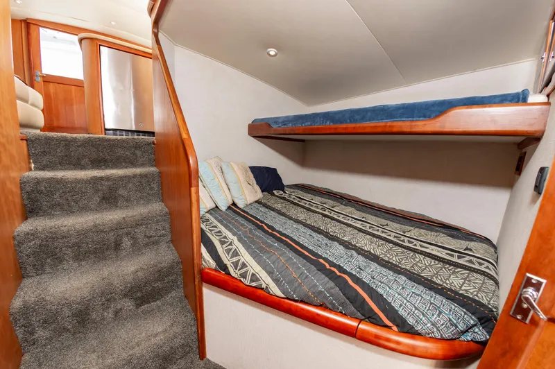 Sea Horse Yacht Photos Pics Interior of 1994 Custom Carolina 43 Blackwell Convertible with cozy bunk beds and carpeted stairs.
