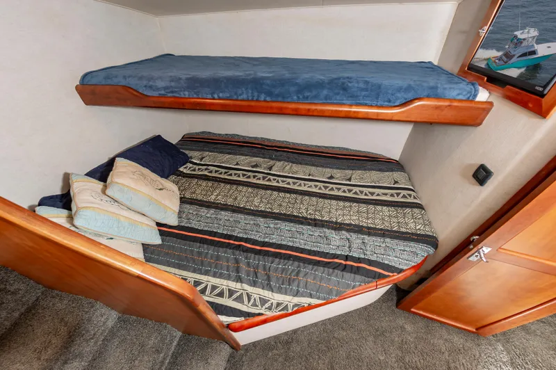 Sea Horse Yacht Photos Pics Cozy cabin interior of 1994 Custom Carolina 43 Blackwell Convertible with bunk beds and patterned bedding.